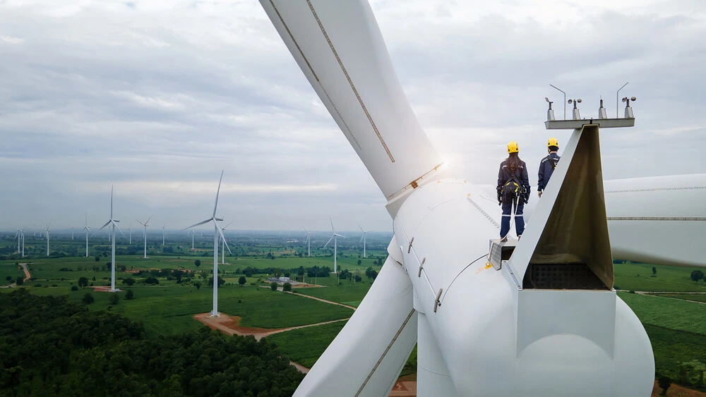 Técnicos no topo de aerogerador em parque eólico